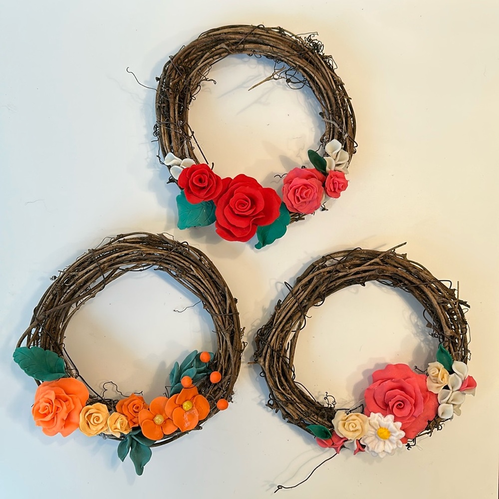 Handcrafted grapevine wreath decorated with clay handmade flowers